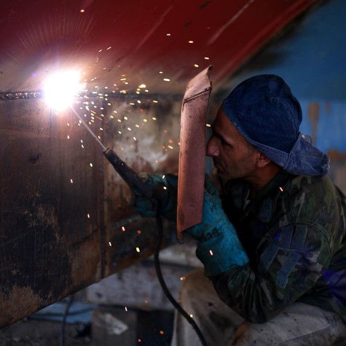 image of a welder using a shield