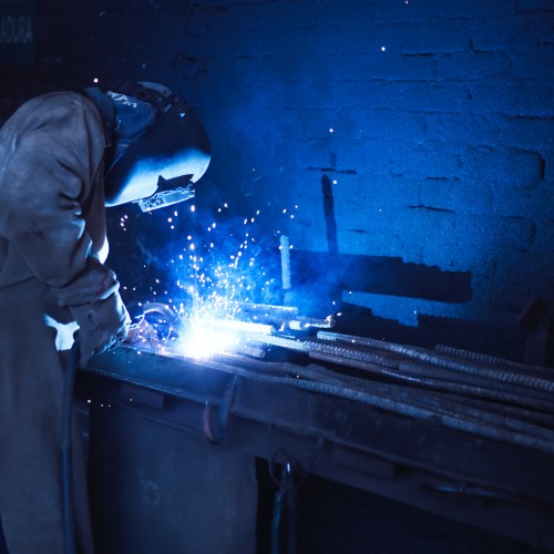 image wearing welder helmet and welding