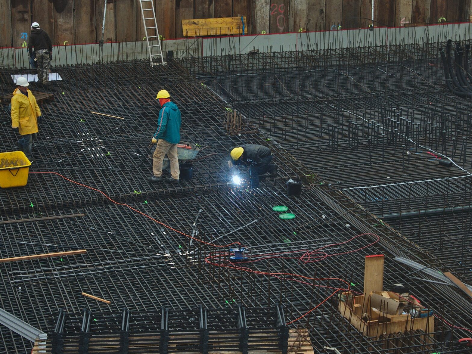Image of construction workers on a site welding